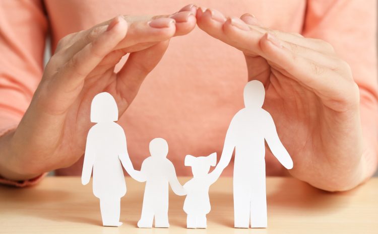 Woman covering paper silhouette of family with hands, closeup Insurance concept