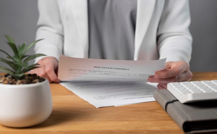 Businesswoman hand with real estate contract, reading and studying it at office desk