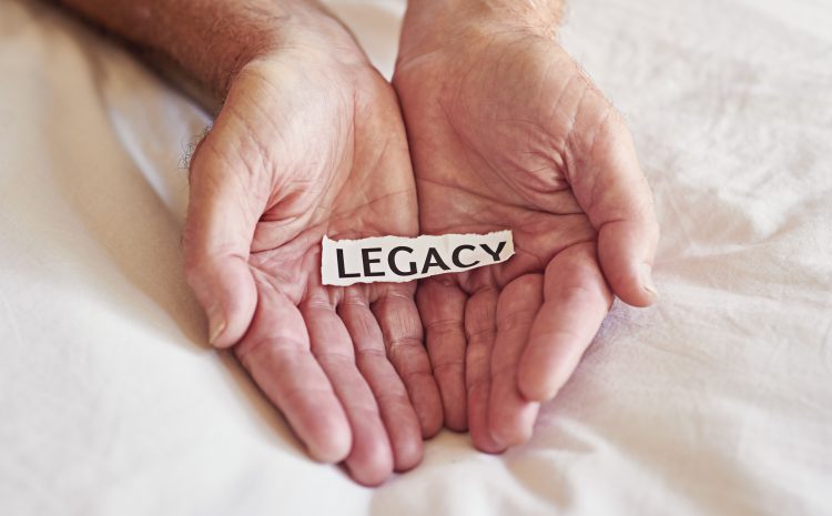 Create a legacy that lasts a lifetime Cropped shot of a person holding a piece of paper with the word legacy written on it