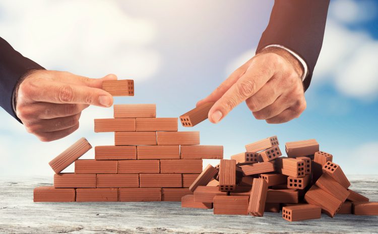 Businessman puts a brick to build a wall Concept of new business, partnership, integration and startup